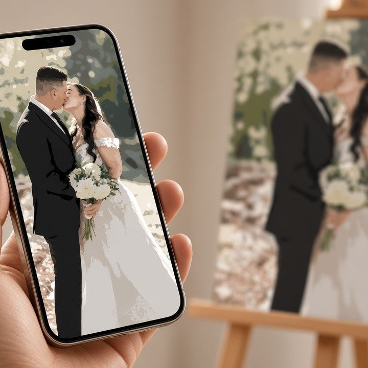 A hand holds a smartphone showing a wedding portrait of a couple, with a blurred canvas print of the same portrait displayed on an easel in the background.